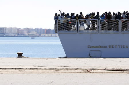 Migrants arrive on the Italian Marines ship Comandante Bettica at the Sicilian harbor of Augusta. REUTERS/Alessandro Bianchi