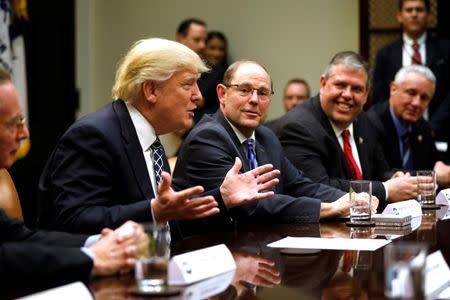 U.S. President Donald Trump (L) meets with Fraternal Order of Police (FOP) National President Chuck Canterbury (2nd L) and other FOP leaders at the White House in Washington, U.S., March 28, 2017. REUTERS/Jonathan Ernst