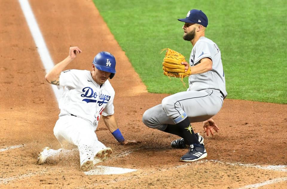 Austin Barnes gets his heel on home plate in front of Rays pitcher Nick Anderson.