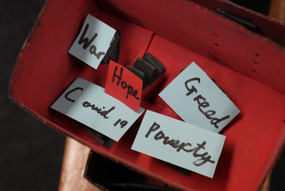 An unfinished 'Pandora's Box' things the pupils of year 3 feel are wrong along with the word 'Hope' is displayed in the classroom at the Holy Family Catholic Primary School in Greenwich, London, Wednesday, May 19, 2021. (AP Photo/Alastair Grant)