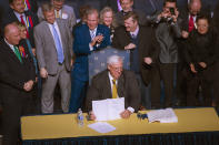 <p>Gov. Jim Justice signs a bill increasing state workers salaries by 5 percent during a news conference at the Culture Center after the House and Senate passed the bill earlier in the day in Charleston, W.Va., on Tuesday, March 6, 2018. The settlement came on the ninth day of a crippling strike that idled hundreds of thousands of students, forced parents to scramble for child care and cast a spotlight on government dysfunction in one of the poorest states in the country. (Photo: Craig Hudson /Charleston Gazette-Mail via AP) </p>