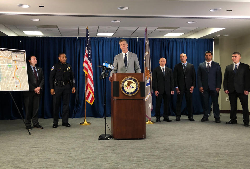 U.S. Attorney for Northern California David Anderson speaks at a news conference, Friday, March 13, 2020, in San Francisco, announcing indictments against 17 alleged members and associates of the MS-13 gang, saying they were trying to take over San Francisco's Mission neighborhood. Homeland Security Investigations special agent in charge Tatum King, left and San Francisco Police Chief William Scott, second from left and on the right are San Francisco police officers. (AP Photo/Janie Har)