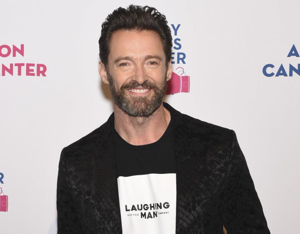 Hugh smiling in a "Laughing Man" top