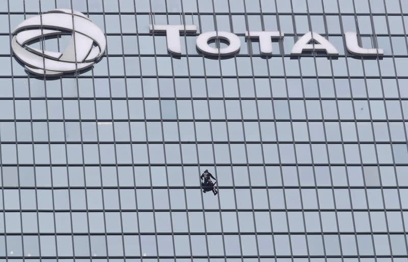 French Spiderman climbs Total tower in support of pensions strikers at La Defense