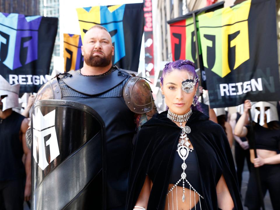 Hafþór Júlíus Björnsson and fitness expert Natalie Eva Marie are dressed in costumes at the launch of Monster Energy’s new performance beverage REIGN Total Body Fuel in 2019 in New York City.