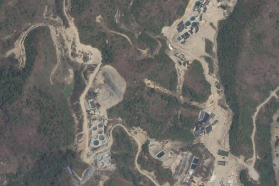 This 2022 satellite image provided by Planet Labs shows rare earth mining pools northwest of Myitkyina, Kachin, Myanmar near the border with China. In the wake of rare earth element mining, an AP investigation has found environmental destruction, the theft of land from villagers and the funneling of money to brutal militias with links to Myanmar's secretive military government. (Planet Labs via AP)