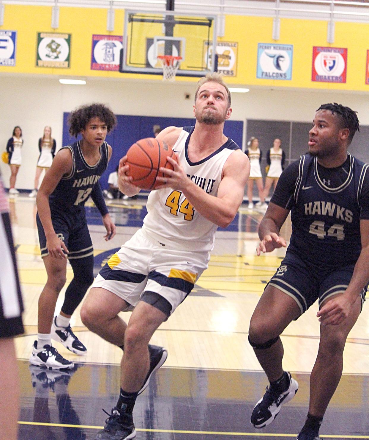 Mooresville senior Nick Wiley (left) goes up for a layup after beating Decatur Central senior Brandon Smith (right) during Friday's Mid-State Conference game against Decatur Central. 