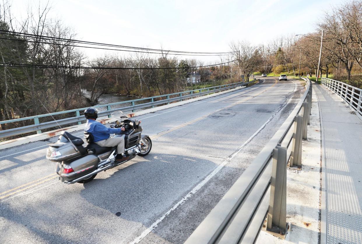 A motorcyclist crosses the bridge over the Cuyahoga River along state Route 91 on March 25i n Munroe Falls.