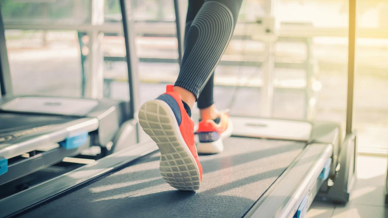 This is a picture of a woman running on a treadmill.