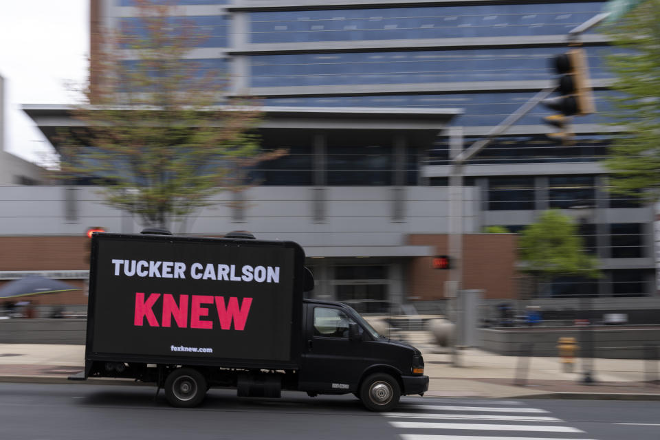 A protest vehicle drives past the justice center in Wilmington, Del., Monday, April 17, 2023, where the Dominion Voting Systems' defamation lawsuit against Fox News is set to take place. The Delaware judge overseeing the voting machine company's $1.6 billion lawsuit has announced a delay in the start of the trial until Tuesday, giving no explanation in announcing the recess. (AP Photo/Matt Rourke)