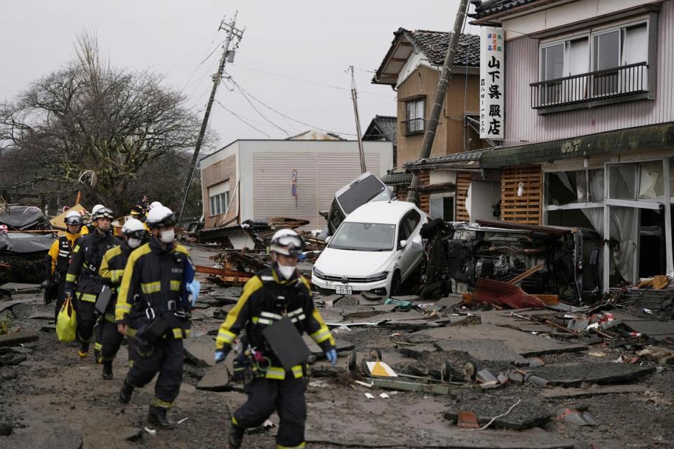 Firefighters search the earthquake-hit area in Suzu, Ishikawa prefecture, Japan