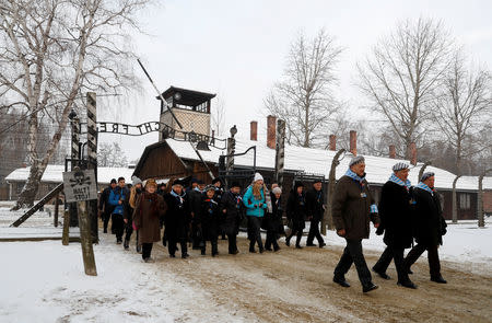 Survivors arrive to lay wreaths at the "death wall" at the former Nazi German concentration and extermination camp Auschwitz, during the ceremonies marking the 74th anniversary of the liberation of the camp and International Holocaust Victims Remembrance Day, in Oswiecim, Poland, January 27, 2019. REUTERS/Kacper Pempel