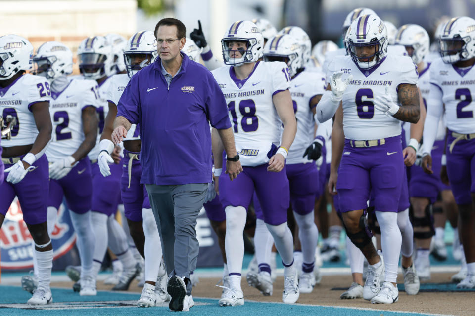 FILE - James Madison head coach Curt Cignetti leads his team onto the field before an NCAA college football game against Coastal Carolina in Conway, S.C., Saturday, Nov. 25, 2023. The Indiana Hoosiers are finalizing a deal to hire Curt Cignetti as their new football coach, two people with direct knowledge of the decision have told The Associated Press. (AP Photo/Nell Redmond, File)