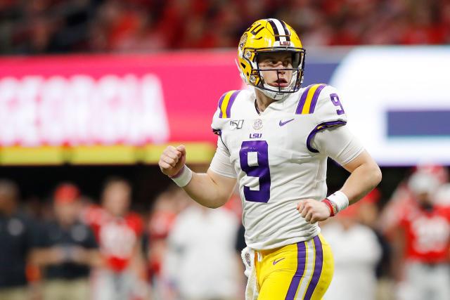 Joe Burrow LSU Tigers Unsigned White Jersey Celebrates Touchdown Photograph