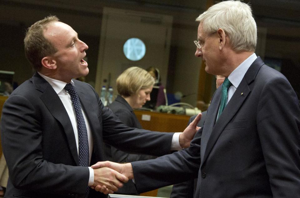 Danish Foreign Minister Martin Lidegaard, left, shakes hands with Swedish Foreign Minister Carl Bildt during a meeting of EU foreign ministers in Brussels on Monday, Feb. 10, 2014. EU foreign ministers on Monday will discuss how to help foster a political situation for the severe crisis that has engulfed Ukraine. The 28 ministers were also weighing the fallout of Sunday’s referendum in Switzerland putting into question the free movement of citizens between the bloc and the Alpine nation. (AP Photo/Virginia Mayo)