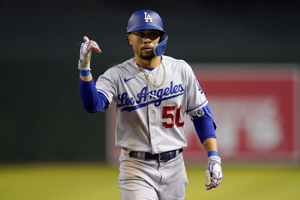Los Angeles Dodgers' Mookie Betts (50) motions to his dugout after a base hit against the Arizona Diamondbacks during the sixth inning of a baseball game, Thursday, May 26, 2022, in Phoenix. (AP Photo/Matt York)