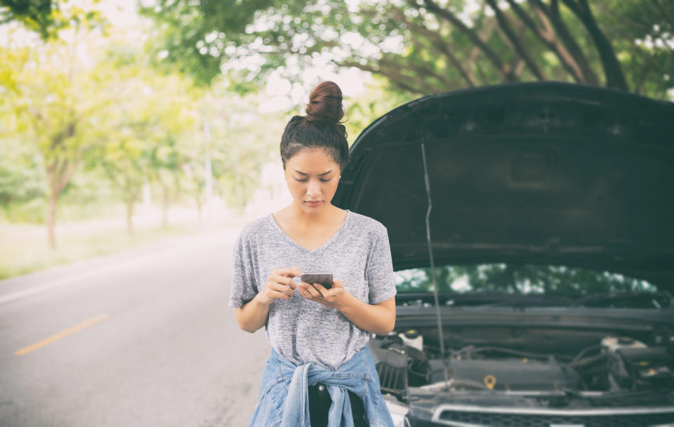 Woman using mobile phone while looking and Stressed man sitting after a car breakdown on street