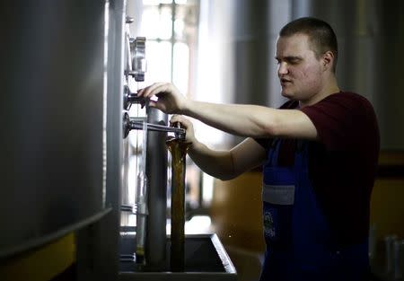 Employee Michael Strohschneider takes a sample of wort in the brewhouse of the 'Kloster Andechs' brewery in Andechs near Munich, Germany, April 19, 2016. REUTERS/Michaela Rehle