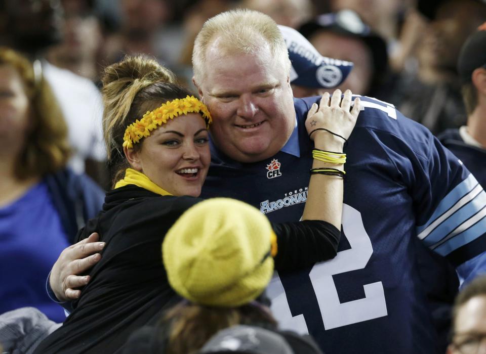 Toronto Mayor Rob Ford poses for a picture with a fan during the CFL eastern final football game between the Toronto Argonauts and the Hamilton Tiger Cats in Toronto, November 17, 2013. REUTERS/Mark Blinch (CANADA - Tags: SPORT FOOTBALL)