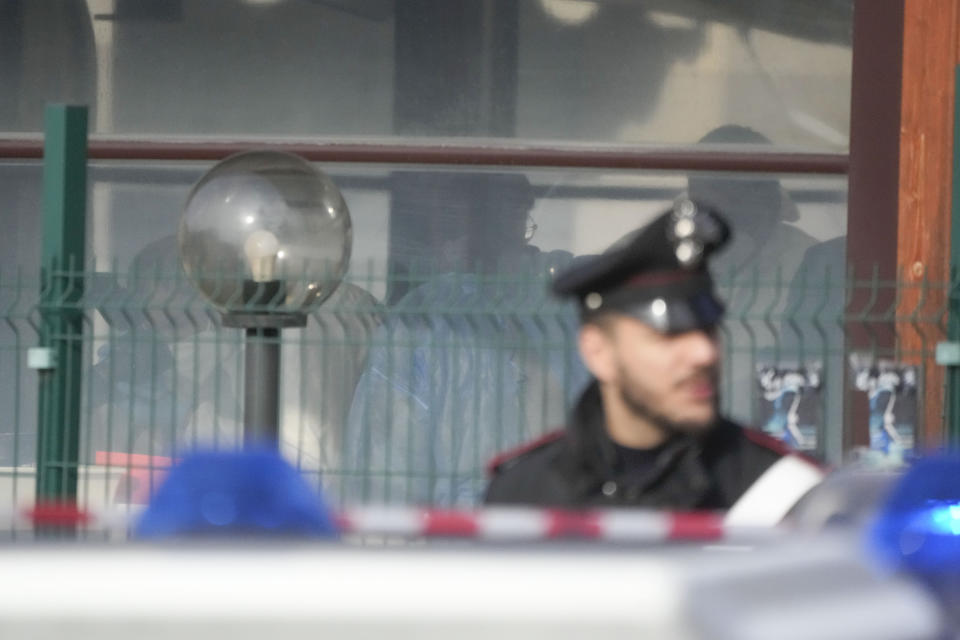 Italian Carabinieri, paramilitary policemen, patrol in front of a bar where three people died after a man entered and shot in Rome, Sunday, Dec. 11, 2022. (AP Photo/Gregorio Borgia)