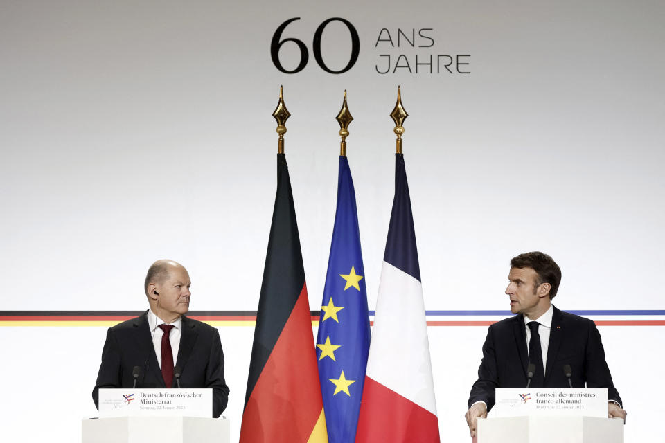 German Chancellor Olaf Scholz, left, and French President Emmanuel Macron attend a joint press conference Sunday, Jan. 22, 2023 at the Elysee Palace in Paris. France and Germany are seeking to overcome differences laid bare by Russia's war in Ukraine and shore up their alliance with a day of ceremonies and talks Sunday on Europe's security, energy and other challenges. (Benoit Tessier, Pool via AP)