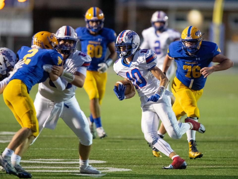 Kyle Maltarich (10) weaves through the Wooster defense to score a first half touchdown for West Holmes.