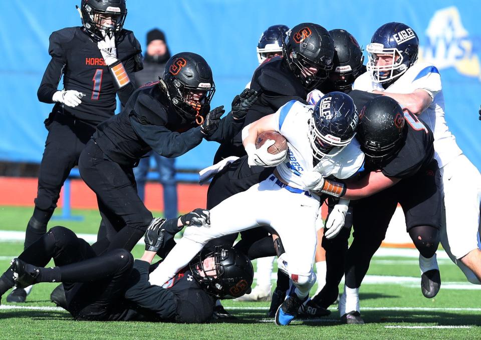 Dobbs Ferry's Jhonatan Almaras (5) gets stopped by a host of Schuylerville defenders during the Class C state semifinal at Middletown High School Nov. 27, 2021. 