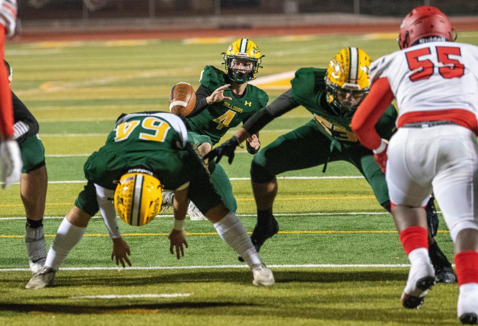 Tracy's Aidan Van Os takes the snap on an extra point against Antelope High on Friday, Nov. 4, 2022.