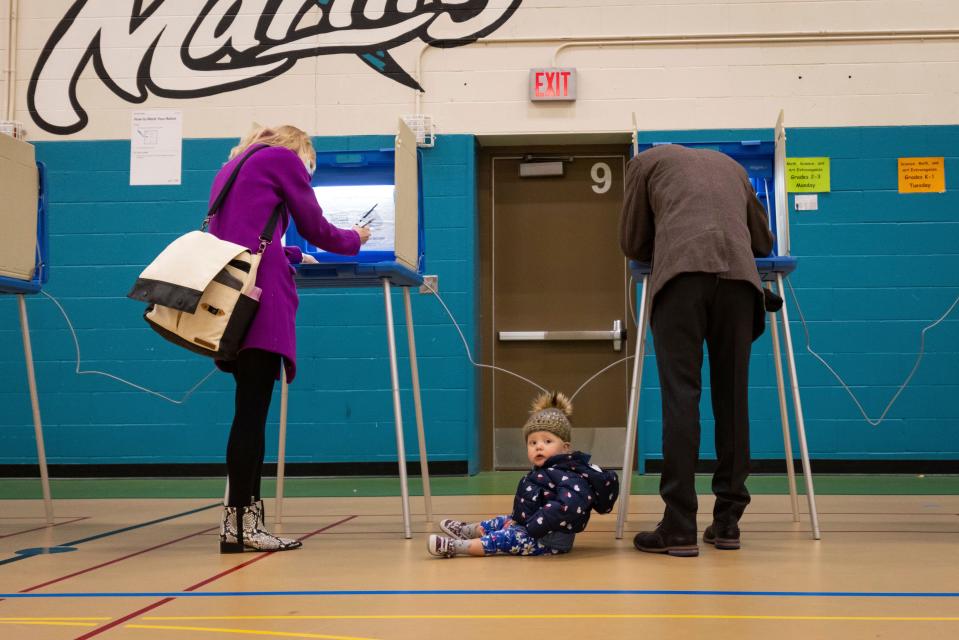 Mayor Jacob Frey casts his vote on Election Day alongside his family at the Marcy Arts Magnet Elementary School on Tuesday, Nov. 2, 2021 in Minneapolis.  Voters in Minneapolis are deciding whether to replace the city’s police department with a new Department of Public Safety. The election comes more than a year after George Floyd’s death launched a movement to defund or abolish police across the country. (AP Photo/Christian Monterrosa) ORG XMIT: MNCM105