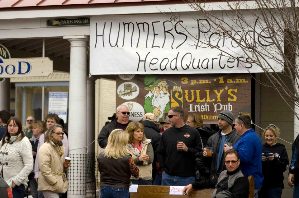 Parade watchers crowd around Sully's Irish Pub at The Witherspoon on Main Street in Middletown during the 2011 Hummers Parade.