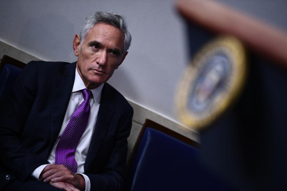 Member of the coronavirus task force Scott Atlas listens to President Trump during a briefing at the White House August 10, 2020, in Washington, DC. (Photo by BRENDAN SMIALOWSKI/AFP via Getty Images)