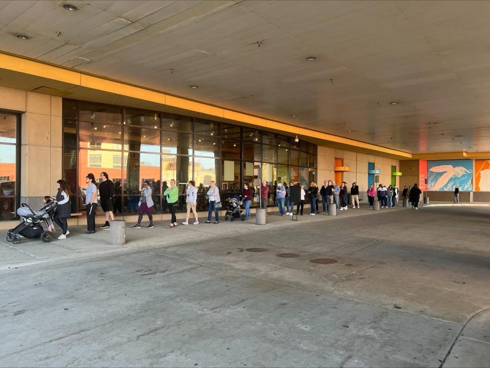 A line to purchase eclipse glasses stretches outside the Grand Rapids Public Museum on Monday, April 8, 2024, in Grand Rapids. By the time the partial eclipse began over Grand Rapids just before 2 p.m., the museum had sold out.