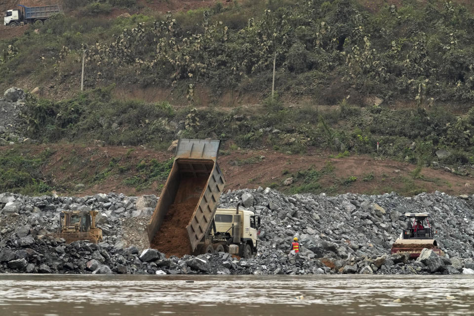 Workers are seen at the construction site of Luang Prabang dam in Luang Prabang, Laos, Sunday, Jan. 28, 2024. Luang Prabang was named a UNESCO World Heritage Site nearly 30 years ago, but a multibillion-dollar dam project is raising questions that could deprive the city of its coveted status and prompting broader concerns the Mekong River could be ruined by multiple dams that are being planned.(AP Photo/Sakchai Lalit)