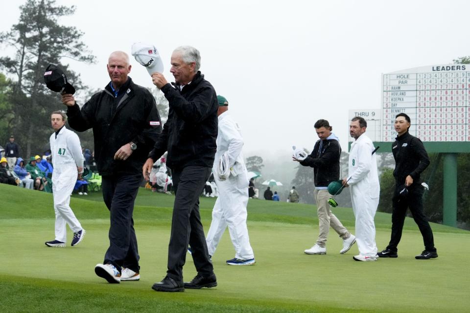 Apr 8, 2023; Augusta, Georgia, USA; Sandy Lyle and Larry Mize wave to patrons as they walk off the 18th green during the second round of The Masters golf tournament. Mandatory Credit: Rob Schumacher-USA TODAY Network