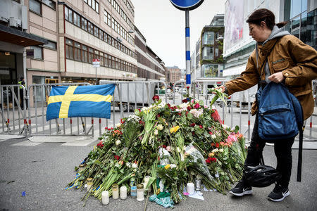 STOCKHOLM 2017-04-08 People gather at a police cordon near the crime scene in central Stockholm on April 08, 2017, the day after a hijacked beer truck plowed into pedestrians on Drottninggatan and crashed into Ahlens department store, killing four people, injuring 15 others. TT News Agency/Noella Johansson/via REUTERS