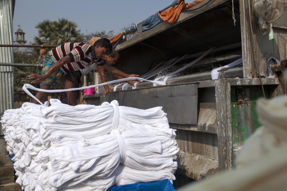 Workers dye cloth for T-shirts at a factory in Narayangonj, Bangladesh. (Photo: Barcroft Media via Getty Images)