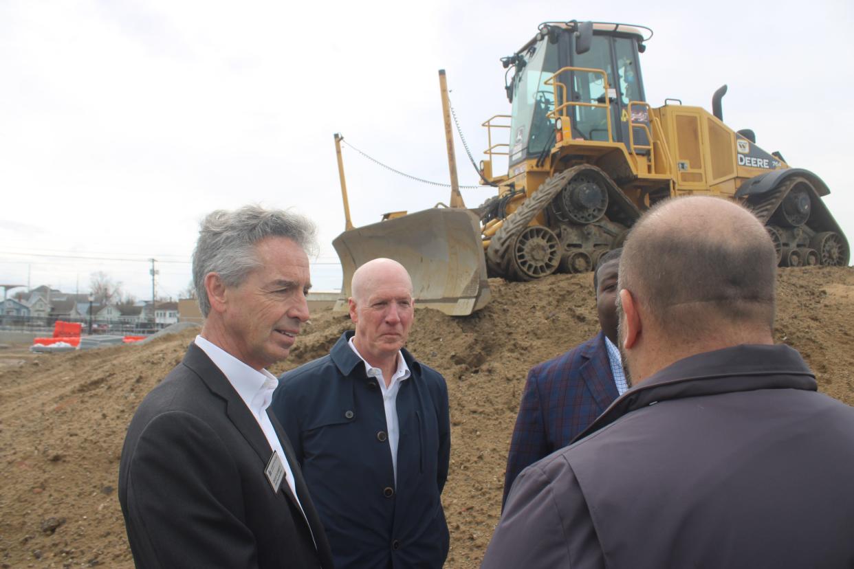 Developers David Flaherty, left, and Jim Crossin, middle, discuss construction of a 12-story apartment tower — The Franklin at 11th Street Station — next to the new South Shore Line commuter train station after a groundbreaking ceremony March 14, 2024, in Michigan City.