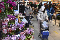 In this photo released by Xinhua News Agency, residents wearing face masks to protect from the coronavirus shop for groceries at a supermarket in Qujiang New District of Xi'an in northwestern China's Shaanxi Province on Jan. 15, 2022. The Chinese city of Xi'an has gradually begun lifting restrictions after over three weeks of lockdown as authorities sought to stamp out a local outbreak before the Beijing Winter Olympic Games are due to start. (Tao Ming/Xinhua via AP)