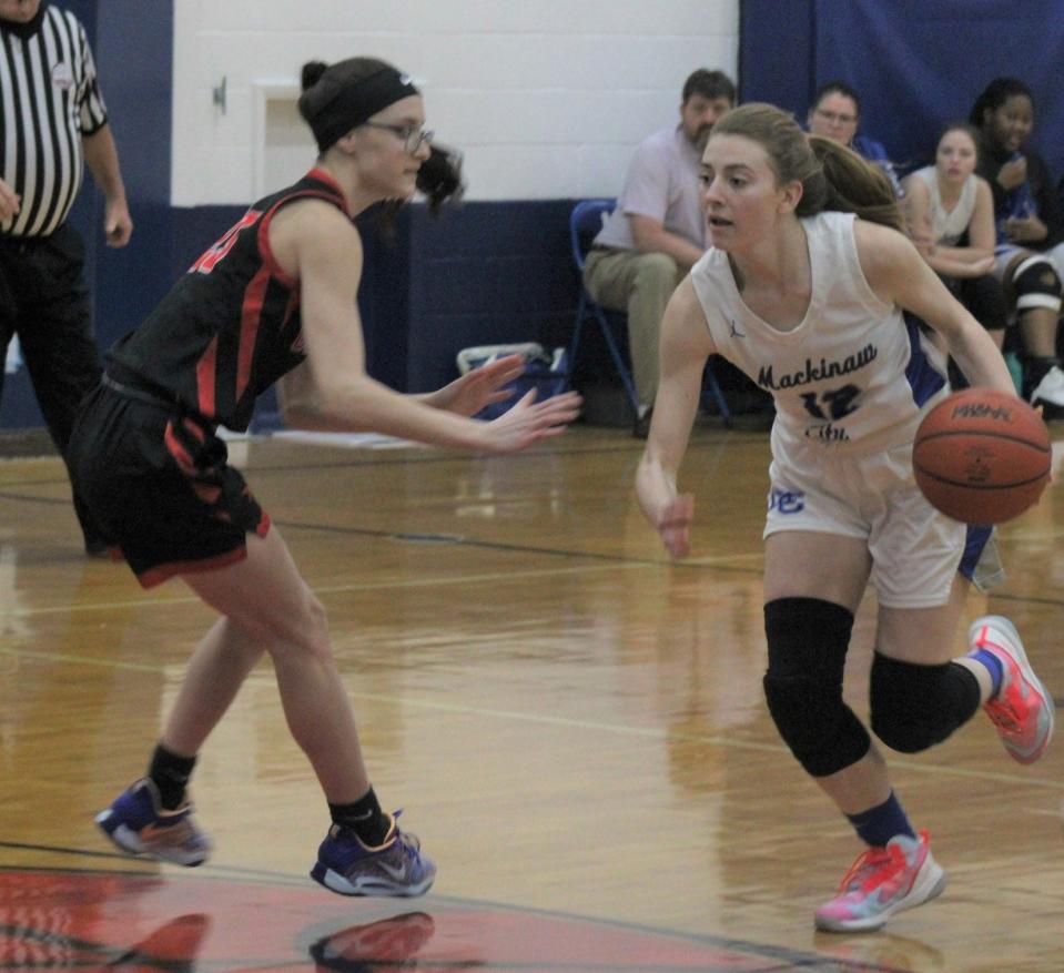 Senior Larissa Huffman (right) recorded a double-double against Ovid-Elsie at Alma College on Saturday, but it wasn't enough as the Mackinaw City girls dropped their first contest of the season.