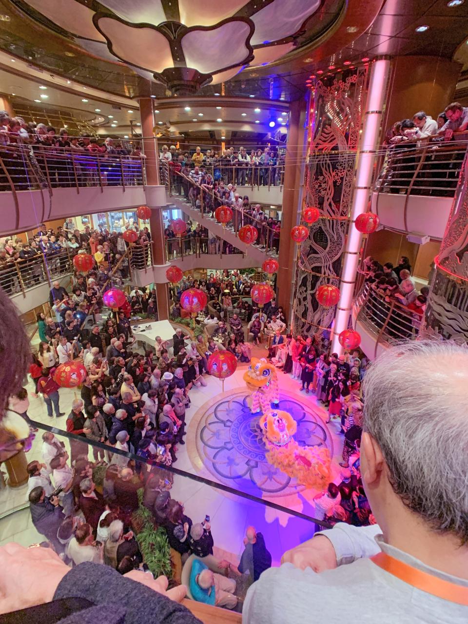 The ship's crowded atrium during one of the cruise's many social events.