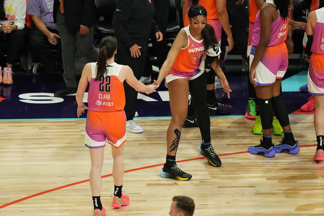 <p>Catalina Fragoso/NBAE via Getty </p> Caitlin Clark (L) and Angel Reese of Team WNBA high five during the game against the USA Basketball Women's National Team during the 2024 WNBA All Star Game on July 20, 2024 at Footprint Center in Phoenix, Arizona