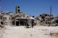 <p>A man walks past damaged houses in the Old City of Aleppo, Syria, July 13, 2017. (Photo: Omar Sanadiki/Reuters) </p>