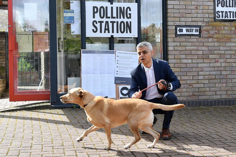 Sadiq Khan poses with his dog Luna on his arrival at a polling station