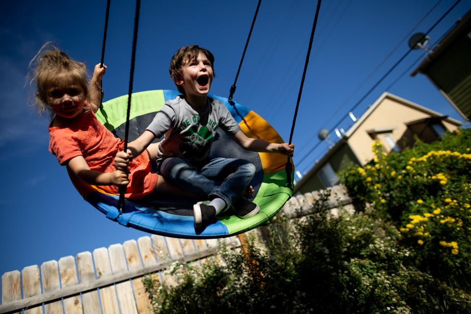 Pyper, 4, and Elliot Mitchell, 6, play on a swing at their home in Midvale on Tuesday, May 30, 2023. | Spenser Heaps, Deseret News