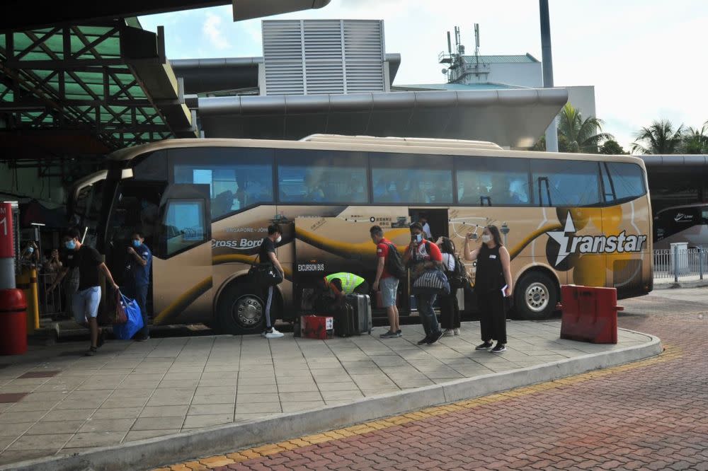 A bus ferrying the first 46 passengers from Singapore arrives at the Larkin Sentral Bus Terminal in Johor Baru November 29, 2021. — Picture by Ben Tan