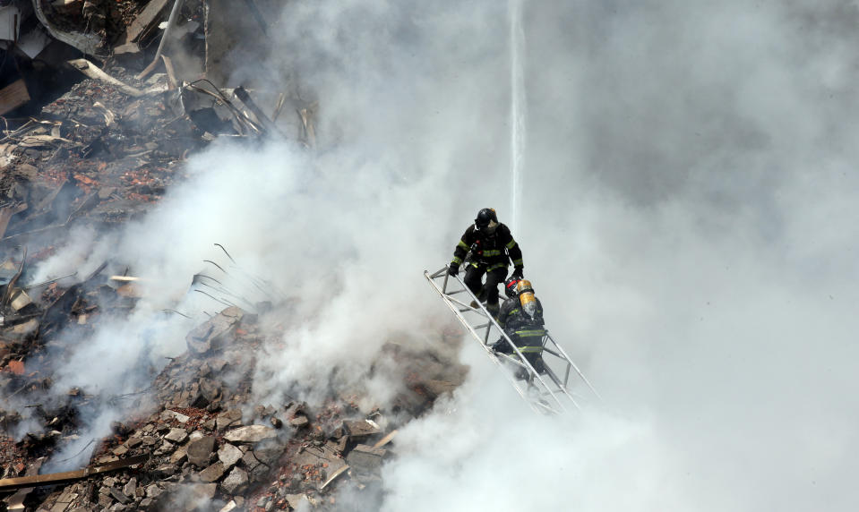 Firefighters try to extinguish a fire at a building in downtown Sao Paulo. Source: Reuters