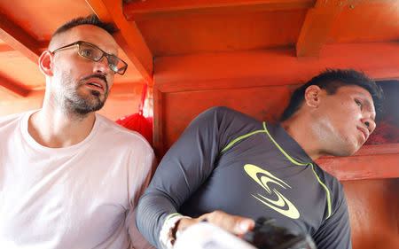 Reuters Manila bureau chief Martin Petty (L) and video journalist Peter Blaza (R) look on while inside a Filipino fishing vessel traversing the Scarborough Shoal in the South China Sea, April 6, 2017. REUTERS/Erik De Castro