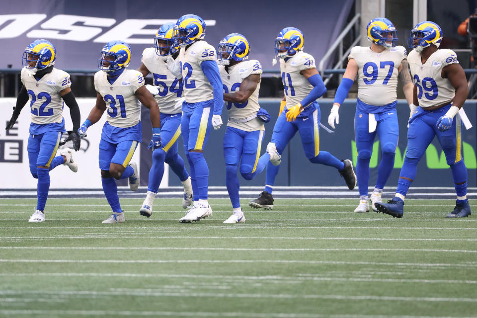 SEATTLE, WASHINGTON - JANUARY 09: Defensive back Darious Williams #31 of the Los Angeles Rams celebrates with teammates after returning an interception for a touchdown during the second quarter of the NFC Wild Card Playoff game against the Seattle Seahawks at Lumen Field on January 09, 2021 in Seattle, Washington. (Photo by Abbie Parr/Getty Images)