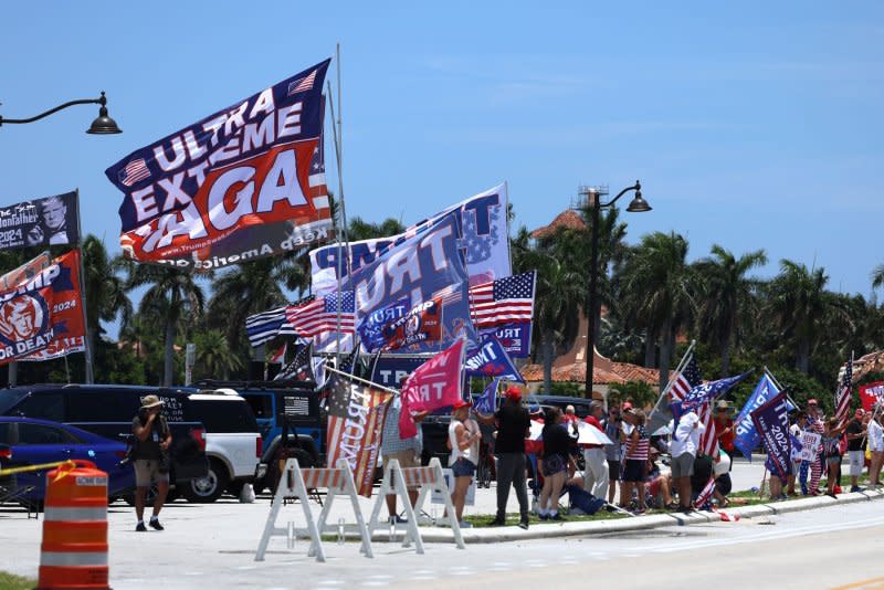 Supporters of former President Donald Trump hold a rally prior to Trump's appearance in Miami Federal Court displaying signs and flags across from Mar-a-Lago in Palm Beach, Florida, on June 11. File Photo by Gary I Rothstein/UPI