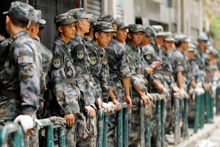 People’s Liberation Army (PLA) soldiers rest as they clean debris after Typhoon Hato hits in Macau, China August 25, 2017. REUTERS/Tyrone Siu